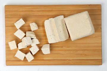 Soyabeans soya bean curd tofu wooden board block slice dice chopped