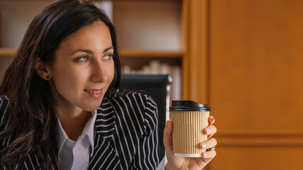 portrait of executive busineswoman with smile holding coffee cup in office