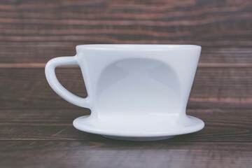 White coffee dripper on wooden background 
