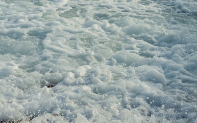 Sea foam on the crest of a wave.