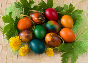 Easter eggs and spring flowers on wooden background