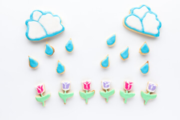 Sugar cookies in the shapes of clouds, raindrops and tulips. A spring concept.