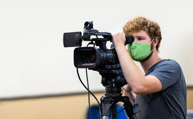 video cameraman with a mask