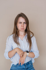Frowning Young girl isolated on beige