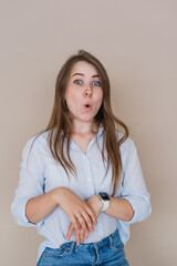 Surprised young girl isolated on beige