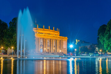 Sunset view of State opera in Stuttgart reflected on water, Germany