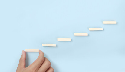 Block stacking as step stair in hand. Business concept