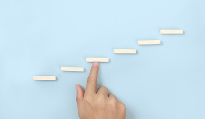 Block stacking as step stair in hand. Business concept