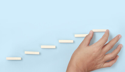 Block stacking as step stair in hand. Business concept