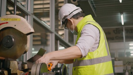 Factory industrial workers technician or engineer worker wear uniforms, safety helmets use a tape measure to measure the steel pipe before cutting with a cutting tool at workshop manufacturing