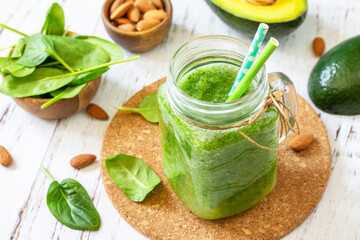 Healthy diet and nutrition, vegan, alkaline, vegetarian concepts. Green smoothie with spinach,...