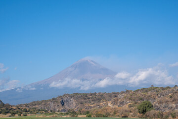 Mesmerizing view of active Popocatepetl volcano in Mexico against a blue sky