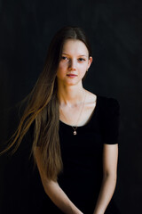Naklejka premium portrait of a young woman in black background