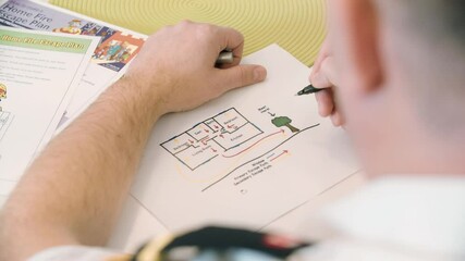 Fire Prevention Officer creating a home escape plan on paper