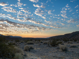 Desert sunrise with scattered fluffy clouds, Mesquite Springs, Death Valley.