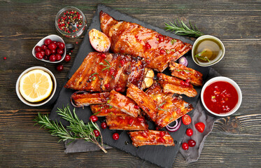 Delicious marinated grilled barbecue spare ribs with different sauces