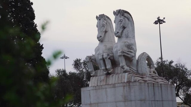 REVEAL of statue of horses with trees in foreground and background