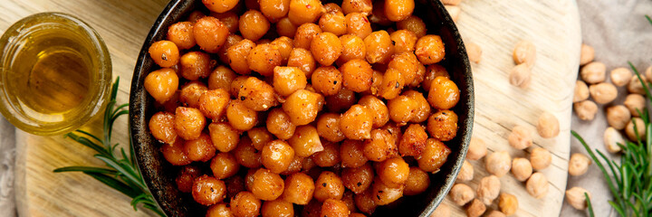 Vegan healthy snack, homemade roasted chickpeas in bowl on light gray background.
