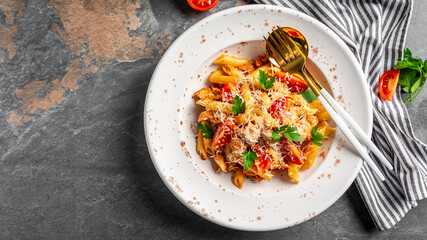 Italian penne pasta with tomato sauce, chicken, tomatoes, cheese parmesan. Italian cuisine. Chicken italian penne pasta. banner, menu recipe place for text, top view
