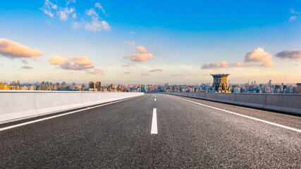 Fototapeta premium Empty asphalt road and Shanghai skyline with buildings at sunset.