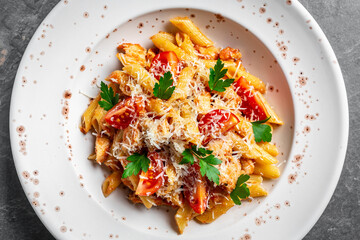 close-up of wholewheat penne bolognese topped with parmesan on a white plate, Italian food. Food recipe background. Close up
