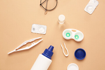 Composition with contact lenses and accessories on color background