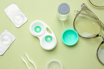 Composition with contact lenses and accessories on color background