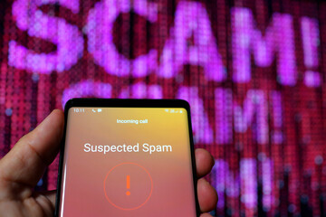 Suspected spam call on a smartphone display screen. Spam telephone call receiving marketing or sales or scam advertising phone call.