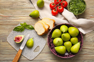 Composition with fresh green figs on wooden background