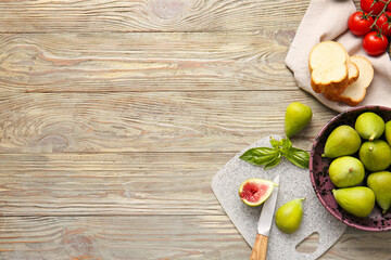 Composition with fresh green figs on wooden background