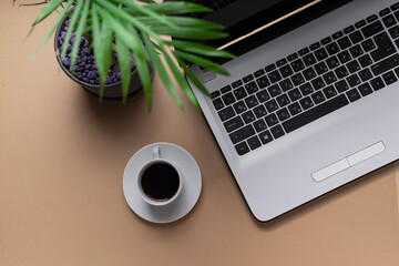 workplace. copyspace. top view. laptop keyboard next to a small cup of espresso coffee
