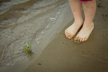 walking barefoot by the river, selective focus