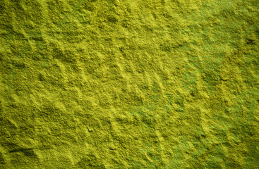 Stone texture with green moss. Beautiful green moss texture abstract wall background, ribbed surface texture with copy space, unusual spotty surface background.