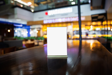 mock up menu frame on the table in the restaurant, put texts or images in the frame, blurred biokeh background