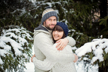 Fototapeta na wymiar Man,woman couple at snow forest