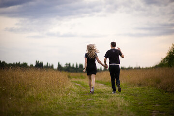 girl and man running across the field, selective focus