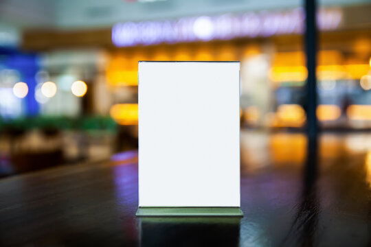 mock up menu frame on the table in the restaurant, put texts or images in the frame, blurred bokeh background