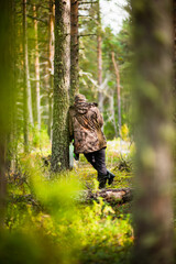 a man stands in a pine forest, selective focus