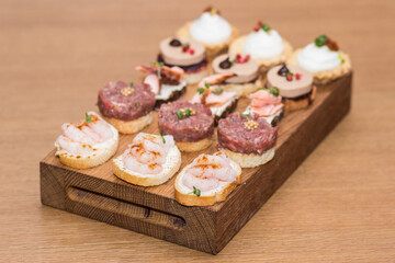 Food snacks and appetizers with cheese, meat  on table. Catering banquet table. Catering party. Corporate event or wedding celebration.