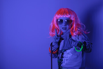 Child wearing a pink wig and heart-shaped sunglasses posed for a photo shooting