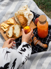person holding a full of fruit. Picnic time