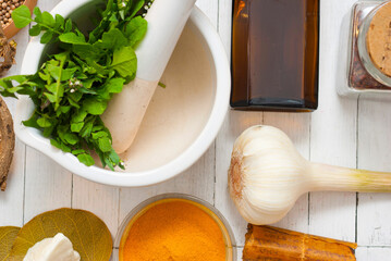 Herbs and spices on white wooden table