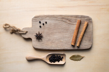 Various spices on rusty wooden background, black pepper, cinnamon stick, star anise, fennel seed - 414857362