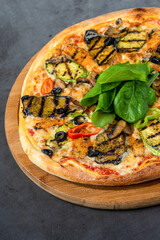 vegetarian pizza with eggplant and zucchini on stone table