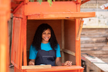 Fototapeta na wymiar african lady in a kiosk smiling