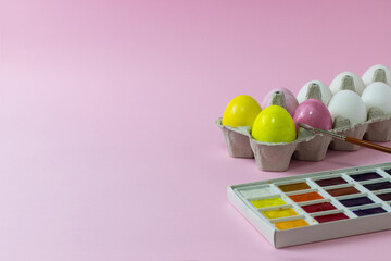 Easter chicken eggs painted on a pink background