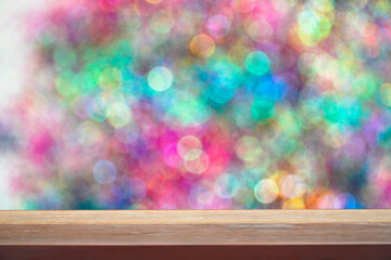 Image of wooden table in front of abstract blurred Colorful Bokeh Background,Colorful Blurred Wallpaper background
