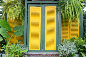The large yellow door was decorated with a variety of plants.
