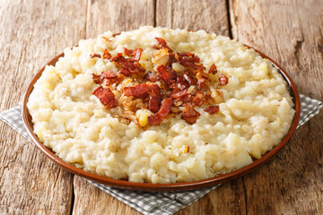 Homemade potato and barley mulgipuder with onion and bacon close-up in a plate on the table. horizontal