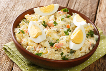 Rustic style Estonian potato salad with cream dressing close-up in a bowl on the table. horizontal